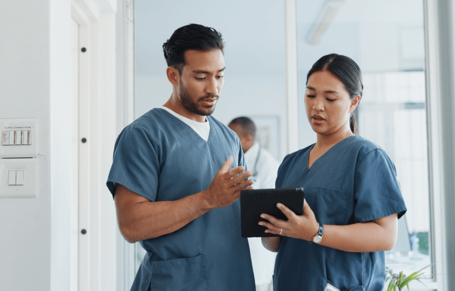 Nurses looking a a tablet