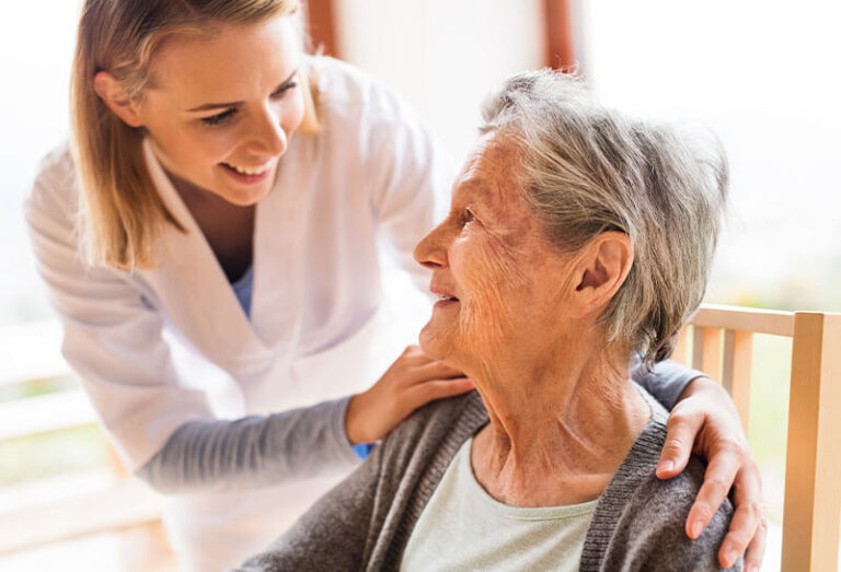 Health visitor and a senior woman during home visit.